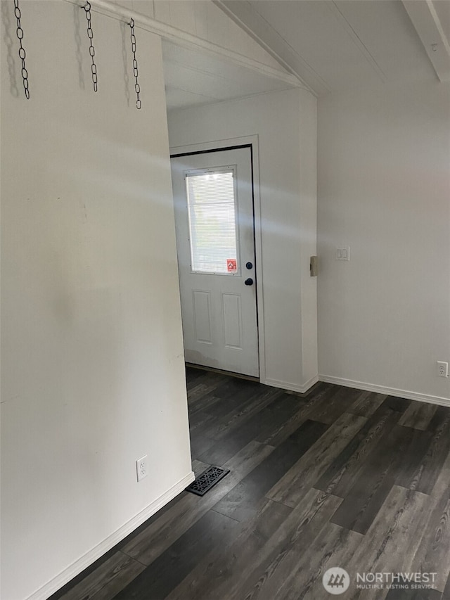 foyer featuring baseboards and dark wood-style flooring