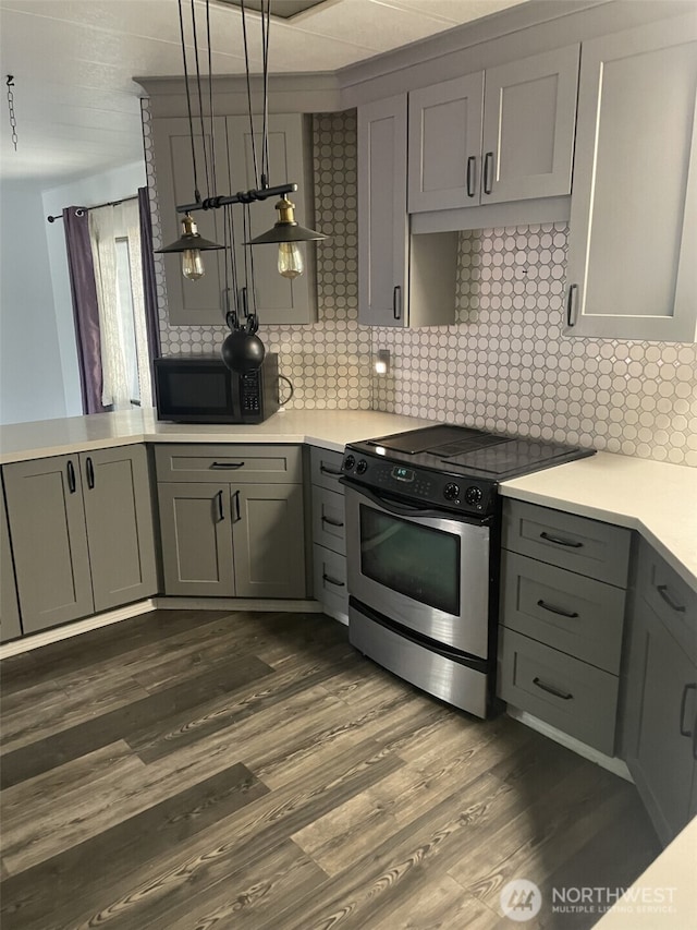kitchen featuring black microwave, light countertops, gray cabinets, and stainless steel range with electric stovetop