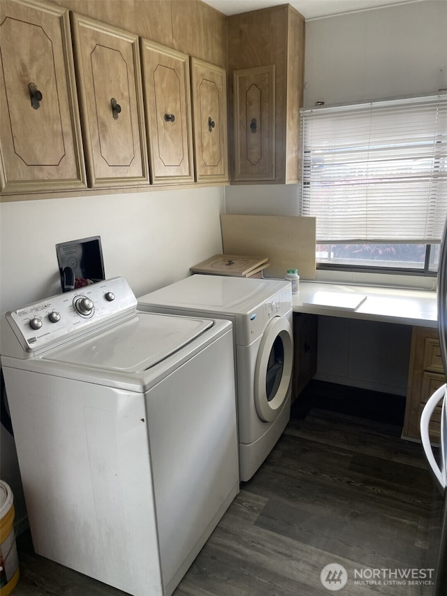 washroom with washer and dryer and dark wood-type flooring