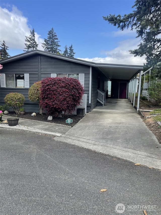 view of front facade featuring an attached carport and concrete driveway