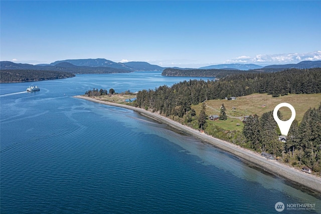 birds eye view of property with a water and mountain view