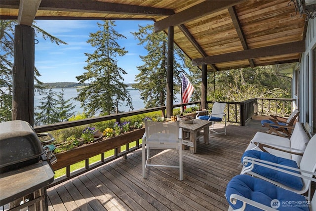 wooden deck featuring a water view