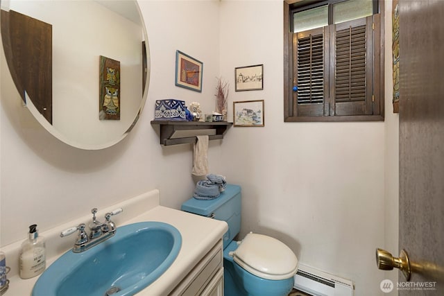 bathroom featuring vanity, baseboard heating, and toilet