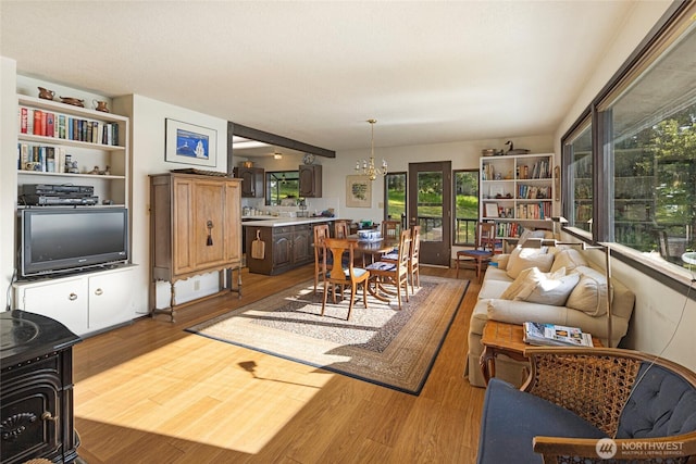 living room featuring wood finished floors and a chandelier