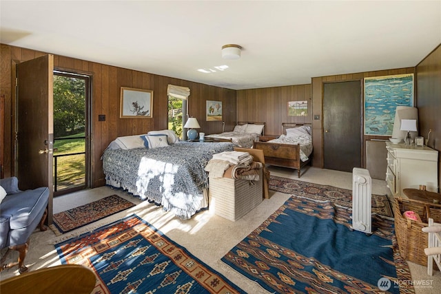 carpeted bedroom with wooden walls
