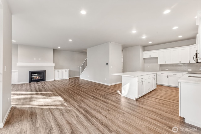 kitchen featuring recessed lighting, baseboards, and light wood-type flooring