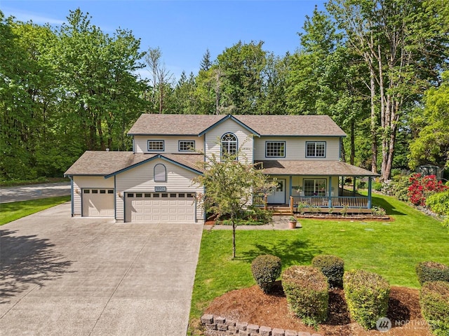 view of front of home with covered porch, concrete driveway, an attached garage, and a front yard