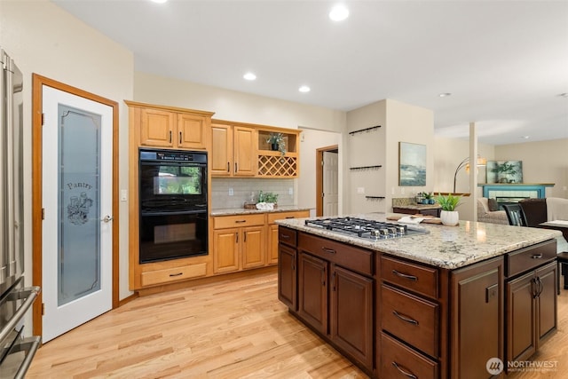 kitchen featuring stainless steel gas cooktop, light wood-style flooring, backsplash, open shelves, and recessed lighting