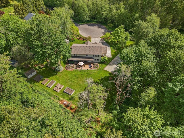 view from above of property featuring a heavily wooded area