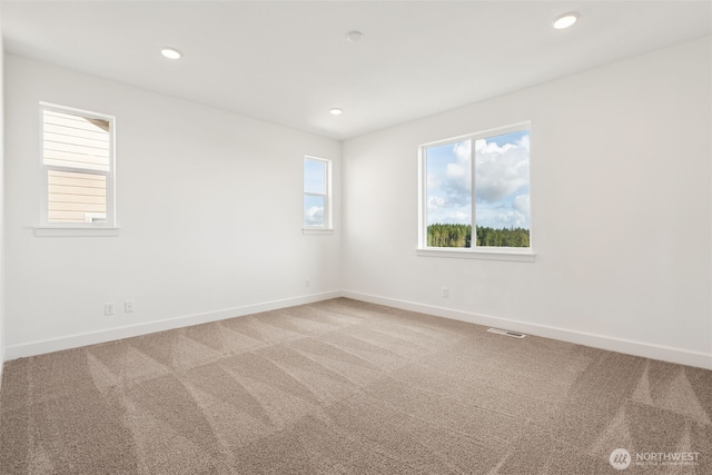carpeted spare room with baseboards, recessed lighting, and visible vents