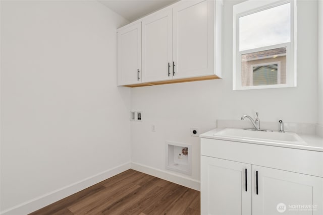 laundry area with cabinet space, washer hookup, a sink, electric dryer hookup, and wood finished floors