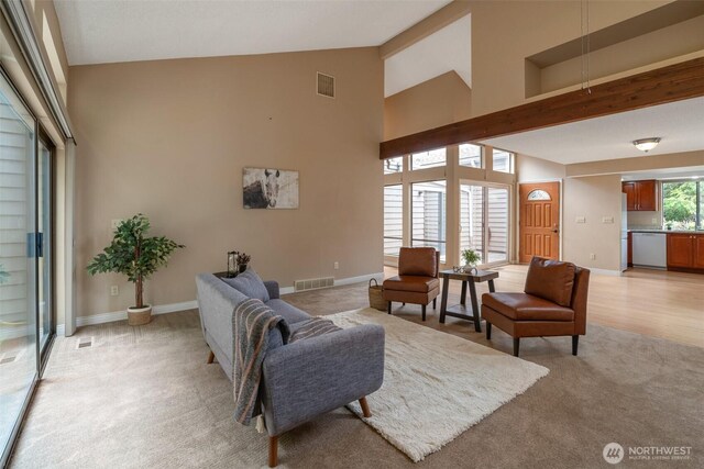 25432 213th Pl SE Unit 4, Maple Valley, WA 98038 - living area with light carpet, baseboards, and high vaulted ceiling