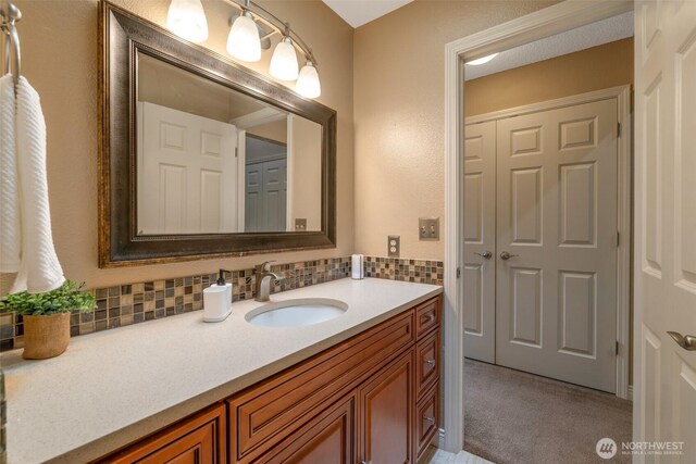 25432 213th Pl SE Unit 4, Maple Valley, WA 98038 - bathroom featuring decorative backsplash and vanity