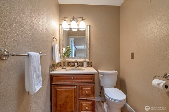 25432 213th Pl SE Unit 4, Maple Valley, WA 98038 - bathroom featuring toilet, vanity, backsplash, and wood finished floors