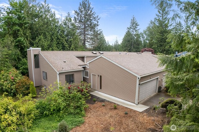 25432 213th Pl SE Unit 4, Maple Valley, WA 98038 - view of property exterior with a garage, roof with shingles, and a chimney