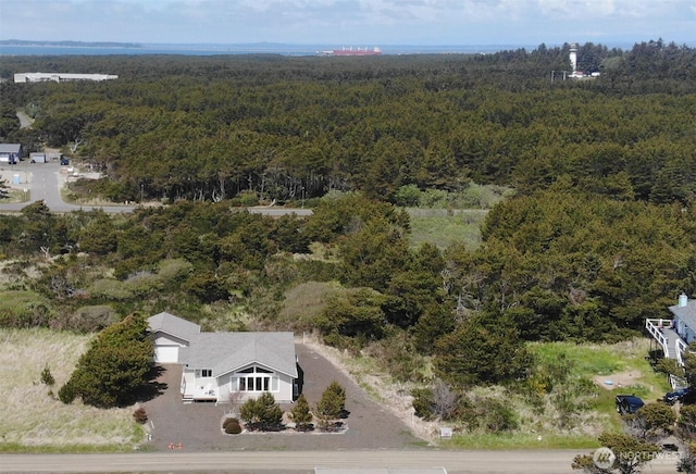 birds eye view of property featuring a view of trees