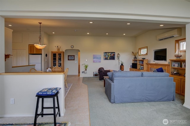 living area with light tile patterned floors, an AC wall unit, and recessed lighting