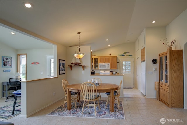 dining room with recessed lighting, lofted ceiling, and light tile patterned flooring