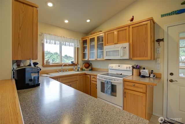 kitchen featuring a sink, vaulted ceiling, white appliances, and a healthy amount of sunlight