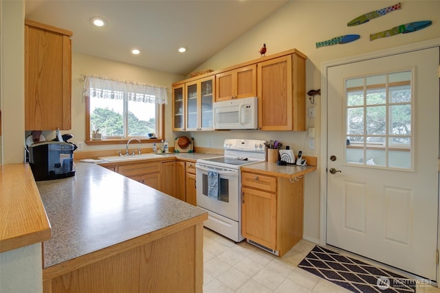kitchen featuring a sink, white appliances, light countertops, lofted ceiling, and glass insert cabinets
