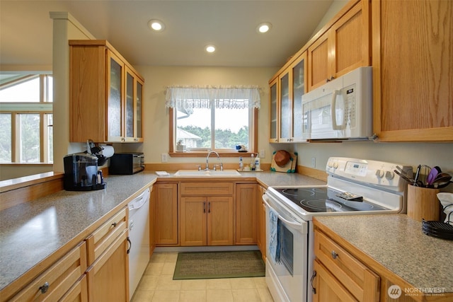 kitchen featuring white appliances, recessed lighting, a sink, and light countertops