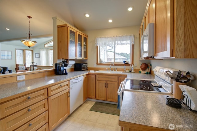 kitchen featuring white appliances, glass insert cabinets, a healthy amount of sunlight, and a sink