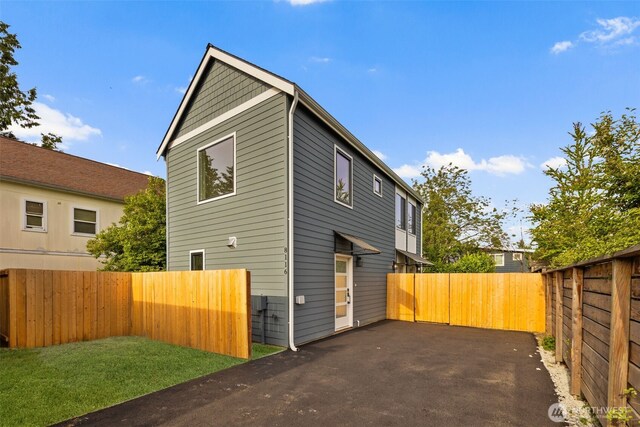 8116 12th Ave SW Unit B, Seattle, WA 98106 - view of side of home with a fenced backyard and a patio