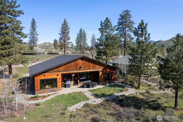 exterior space with a mountain view and a patio