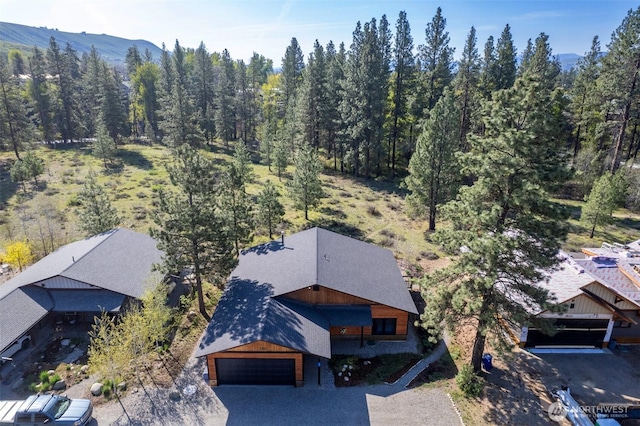 aerial view featuring a mountain view and a forest view