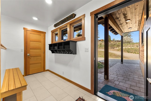 doorway featuring baseboards and recessed lighting