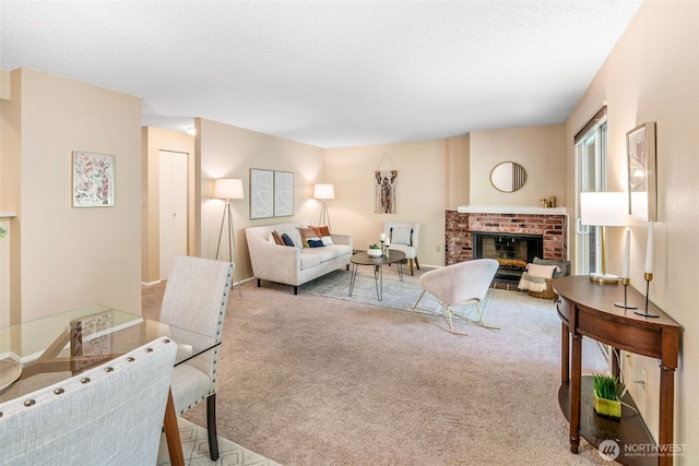 carpeted living area with a brick fireplace