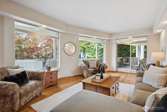 living area featuring light wood-style flooring and recessed lighting