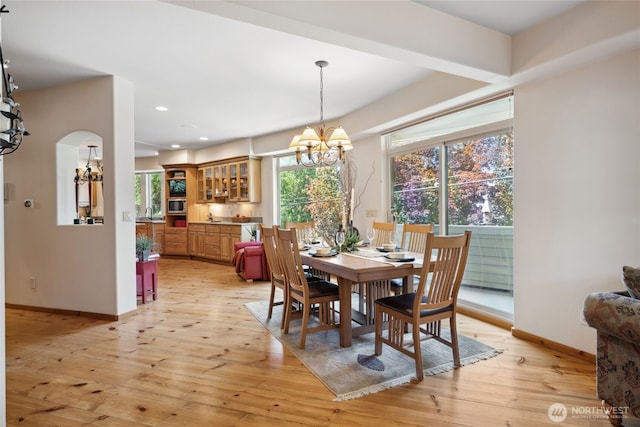 dining room featuring a chandelier, baseboards, light wood-style floors, and recessed lighting