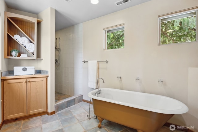 full bathroom featuring a stall shower and a freestanding tub