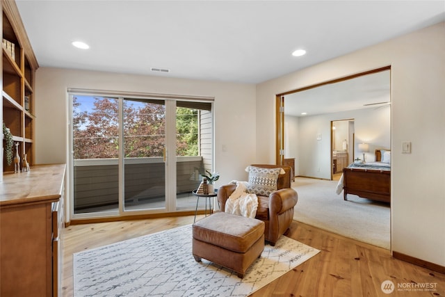 sitting room featuring light wood-style floors, recessed lighting, and baseboards