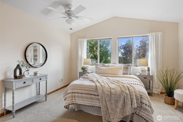bedroom with vaulted ceiling, light carpet, baseboards, and a ceiling fan
