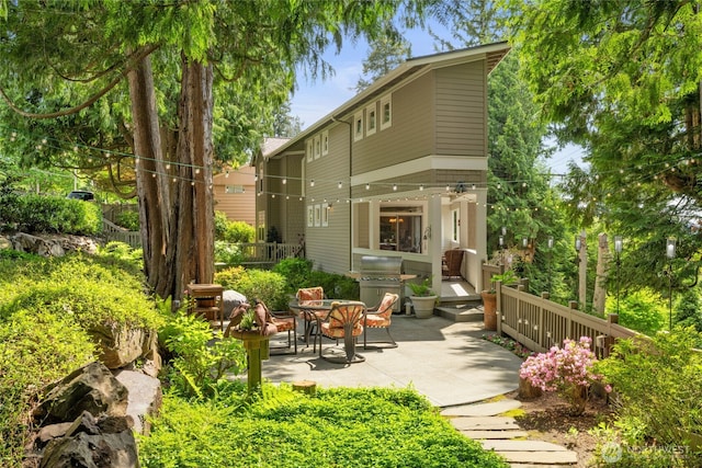 back of property featuring a patio area and fence