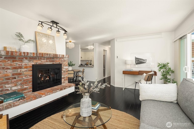 living area featuring a fireplace and wood-type flooring