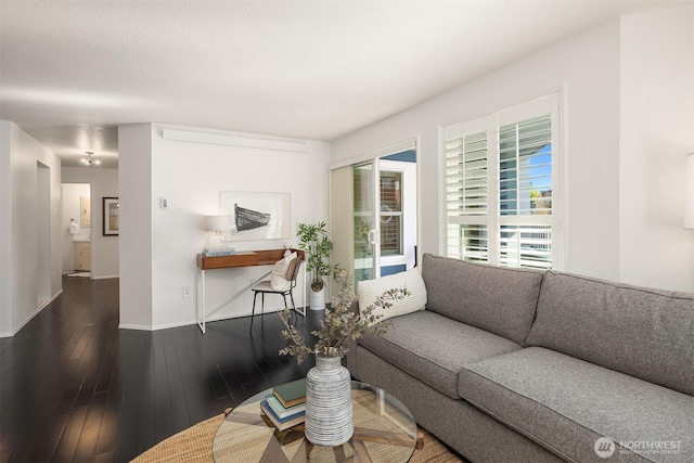 living room with baseboards and hardwood / wood-style flooring