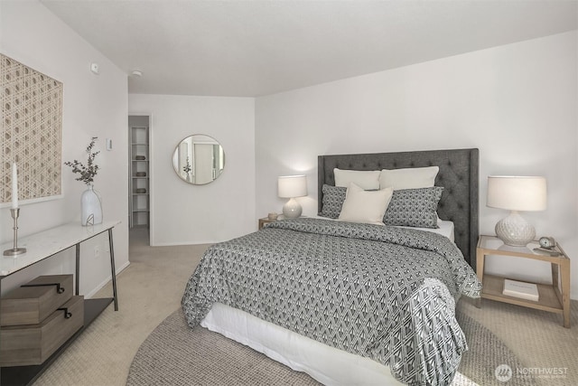 bedroom featuring light carpet and baseboards