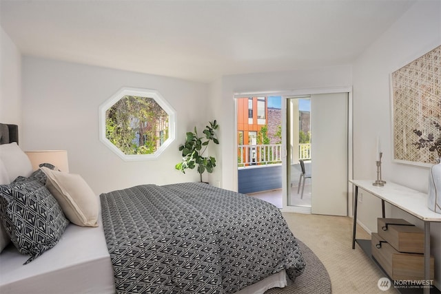 bedroom with access to outside and light colored carpet