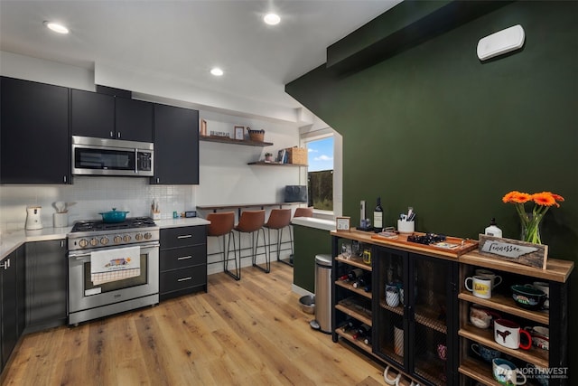 9429 18th Ave SW Unit A, Seattle, WA 98106 - kitchen with appliances with stainless steel finishes, open shelves, dark cabinets, light countertops, and recessed lighting
