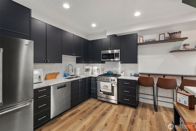 9429 18th Ave SW Unit A, Seattle, WA 98106 - kitchen with high quality appliances, dark cabinets, a sink, open shelves, and recessed lighting