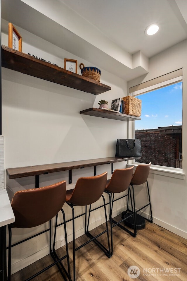9429 18th Ave SW Unit A, Seattle, WA 98106 - bar featuring wood finished floors, baseboards, and recessed lighting
