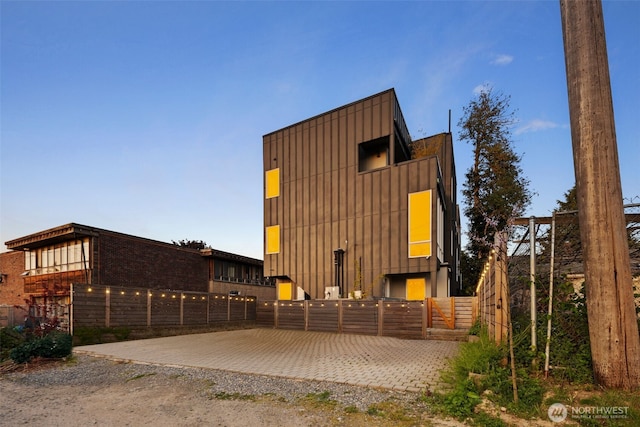 9429 18th Ave SW Unit A, Seattle, WA 98106 - rear view of property featuring fence and board and batten siding
