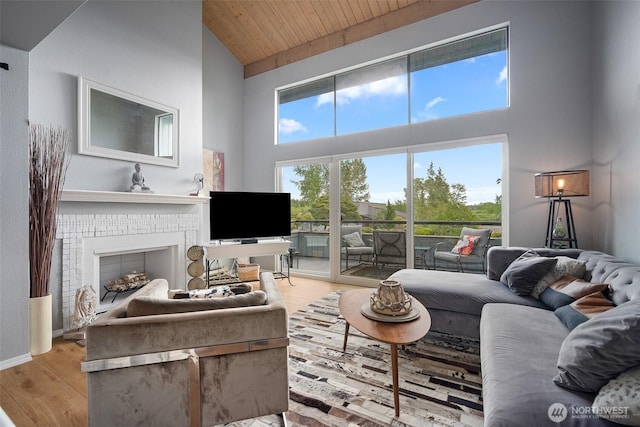 7806 Birch Bay Dr Unit 808, Blaine, WA 98230 - living area with high vaulted ceiling, wood ceiling, wood finished floors, a fireplace, and baseboards
