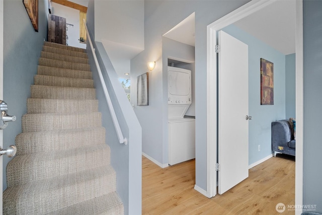 7806 Birch Bay Dr Unit 808, Blaine, WA 98230 - staircase featuring stacked washer / dryer, wood finished floors, and baseboards