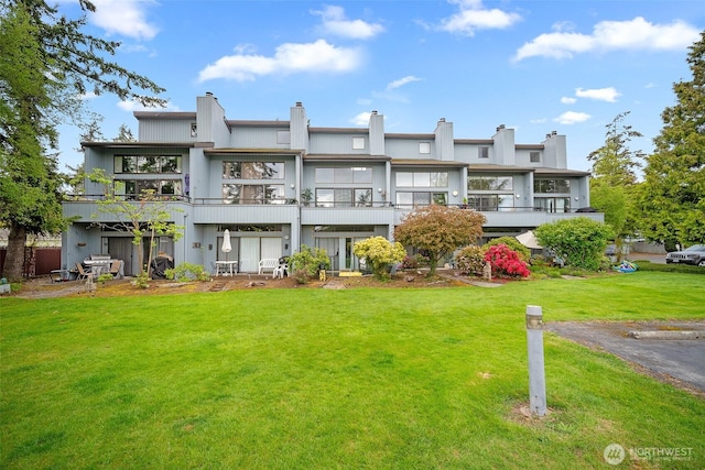 7806 Birch Bay Dr Unit 808, Blaine, WA 98230 - rear view of property with a yard, a chimney, and a balcony
