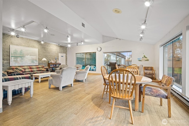 7806 Birch Bay Dr Unit 808, Blaine, WA 98230 - dining area featuring track lighting, light wood-style flooring, vaulted ceiling, and a baseboard radiator
