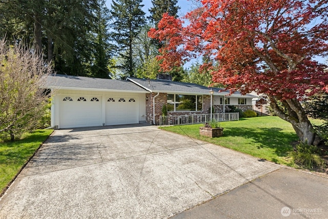 ranch-style house featuring covered porch, a front yard, brick siding, concrete driveway, and an attached garage